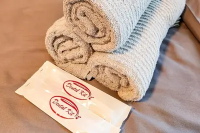 a towel and a bag of soap next to a person at Boho City View 1br Apt in Makati with Netflix in Manila