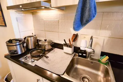 a kitchen counter top with a sink and a sink at Boho City View 1br Apt in Makati with Netflix in Manila