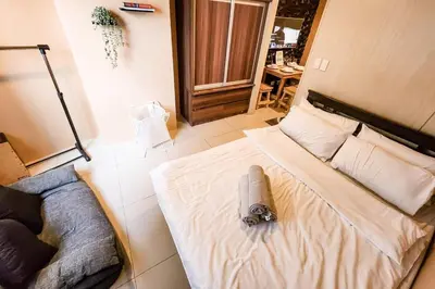 a bedroom with a bed with a toy on it at Cozy Pool & City View 1br Apt in Makat with Netflix in Manila