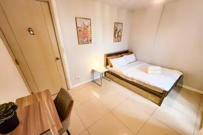 a small room with a bed and a table at Amazing City View 2br apartment in Makati - 70sqm in Manila