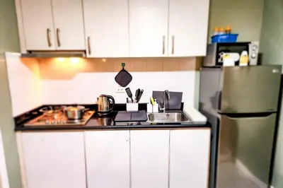 a kitchen with a sink and a refrigerator at Amazing City View 2br apartment in Makati - 70sqm in Manila