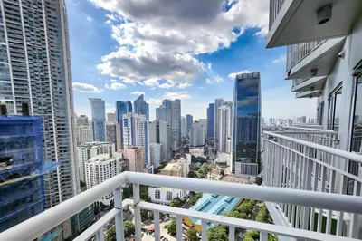 a view from a balcony of a city skyline at Amazing City View 2br apartment in Makati - 70sqm in Manila