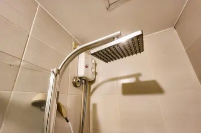 a shower with a shower head in a bathroom at Amazing City View 2br apartment in Makati - 70sqm in Manila