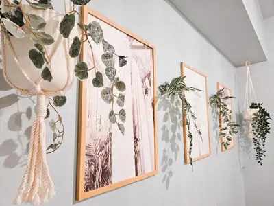 a bunch of plants hanging on a wall at Luxury 2br in Makati with Billiard & Netflix in Manila