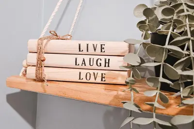 a stack of books with the words live laugh love at Luxury 2br in Makati with Billiard & Netflix in Manila