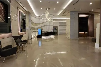 a lobby with chairs and a television in a building at Luxury 2br in Makati with Billiard & Netflix in Manila