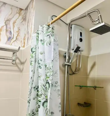 a shower curtain in a bathroom next to a shower at Jessa Rios Coast Staycation in Manila