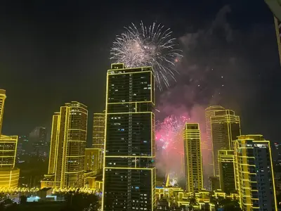 a fireworks display in a city with tall buildings at Acqua Escape in Manila