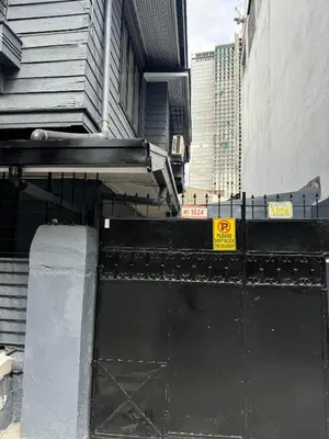 a black gate in front of a building at 88Ap Lodging House San Marcelino in Manila