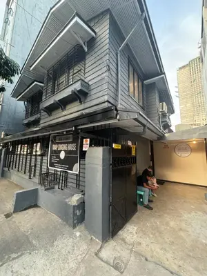 a building with a sign in front of it at 88Ap Lodging House San Marcelino in Manila