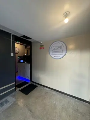 a room with a white wall with a sign on it at 88Ap Lodging House San Marcelino in Manila