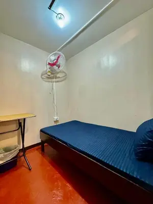 a small room with a bed and a fan at 88Ap Lodging House San Marcelino in Manila