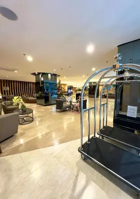 a lobby with a staircase in a building at Divine Staycation in Manila