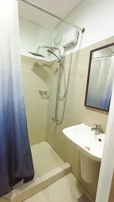 a bathroom with a sink and a shower at Divine Staycation in Manila
