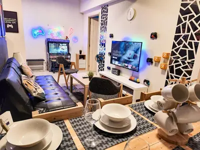 a living room with a couch and a tv at Gaming 2br in Makati with City View Arcade Netflix in Manila