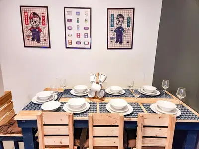 a dining room table with white plates and chairs at Gaming 2br in Makati with City View Arcade Netflix in Manila