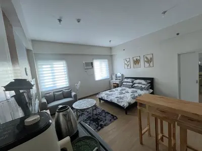 a living room with a bed and a couch at Aras Solace Place in Trece Martires