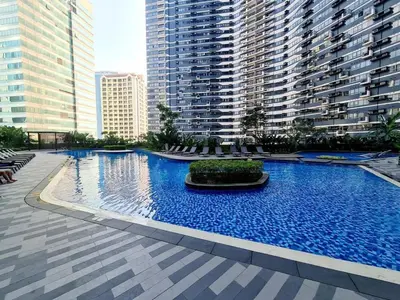 a large swimming pool in a city with tall buildings at City Scape Comforts Makati in Manila