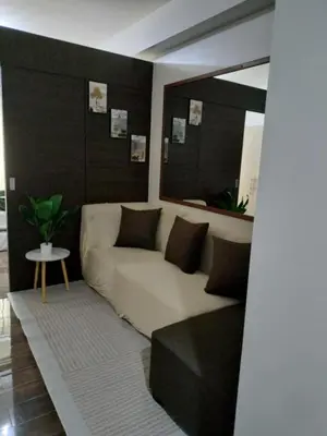 a living room with a couch and a table at City Scape Comforts Makati in Manila