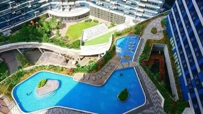 an aerial view of a building with a swimming pool at City Scape Comforts Makati in Manila