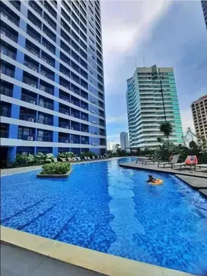 a large swimming pool in a city with tall buildings at City Scape Comforts Makati in Manila