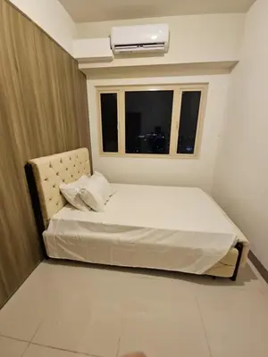 a small bedroom with a bed and a window at Condo next door 3 in Manila
