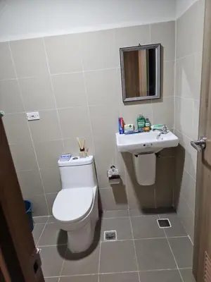 a bathroom with a toilet and a sink at Condo next door 3 in Manila