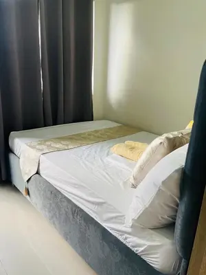 a bed with white sheets and pillows next to a window at 1126 S Residences SMDC Condo near W Mall & MOA by Prime Stay in Manila