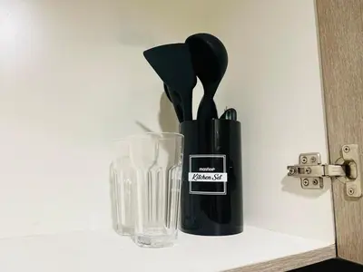 a black vase sitting on a shelf next to a glass at 1126 S Residences SMDC Condo near W Mall & MOA by Prime Stay in Manila