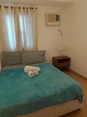 a bedroom with a bed with two towels on it at The Embassy Pods in Manila