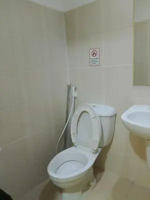 a bathroom with a toilet and a sink at The Embassy Pods in Manila