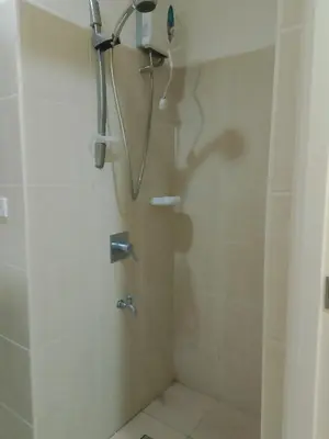 a bathroom with a shower with a shower head at The Embassy Pods in Manila