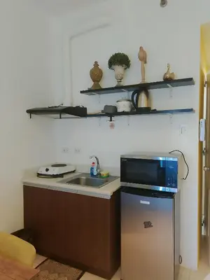 a kitchen with a sink and a microwave at The Embassy Pods in Manila