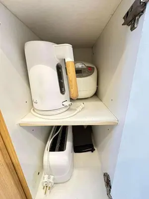 a coffee maker and a blender on a shelf at Condo near MOA and NAIA in Manila