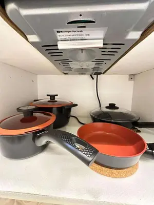 a room with three pots and pans and a ceiling at Condo near MOA and NAIA in Manila