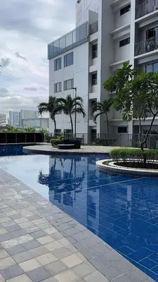 a swimming pool in front of a building at Shore 2 Tower 3 Modern Loft Near Mall of Asia in Manila