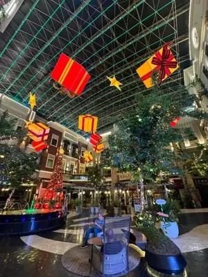 a mall with christmas trees and presents hanging from the ceiling at One Palm Tree Villas Studio w fast WiFi, across from NAIA Terminal 3 in Manila