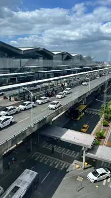 a parking lot with cars parked on a highway at One Palm Tree Villas Studio w fast WiFi, across from NAIA Terminal 3 in Manila