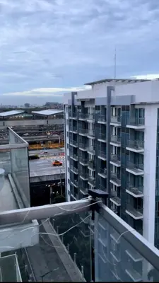 a view of a building from the balcony of a building at One Palm Tree Villas Studio w fast WiFi, across from NAIA Terminal 3 in Manila