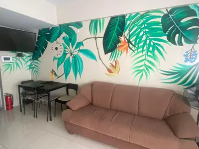 a living room with a couch and a table at One Palm Tree Villas Studio w fast WiFi, across from NAIA Terminal 3 in Manila