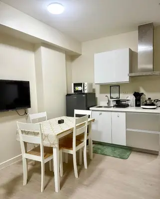 a small kitchen with a table and chairs in a kitchen at Verte Hideaway at Azure Residences - Urban Escape in Manila