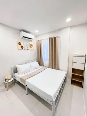 a white bedroom with a large bed in it at Casa Viana - Modern House Upto 300mbps Wi-fi with Netflix, FREE Parking in Cabuyao