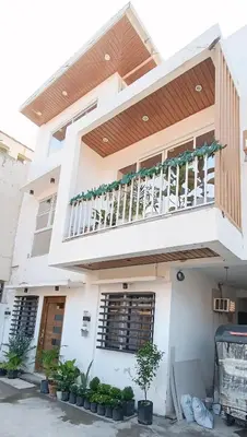 a white house with a balcony on top of it at Casa Viana - Modern House Upto 300mbps Wi-fi with Netflix, FREE Parking in Cabuyao