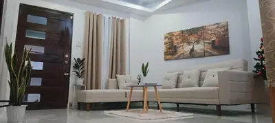 a living room with a couch and a table at Casa Viana - Modern House Upto 300mbps Wi-fi with Netflix, FREE Parking in Cabuyao