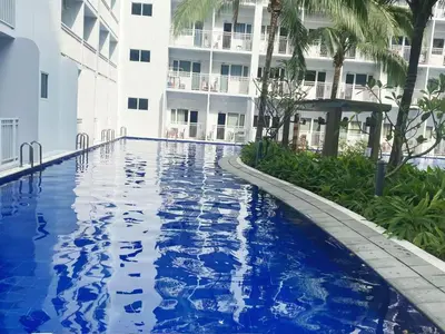 a swimming pool in front of a building at Modern Studio Condo - Shore near MOA- 403B in Manila