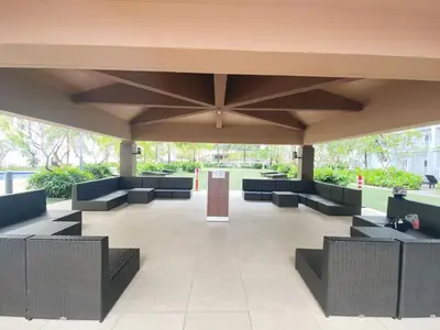 a large covered area with chairs and tables at Modern Studio Condo - Shore near MOA- 403B in Manila