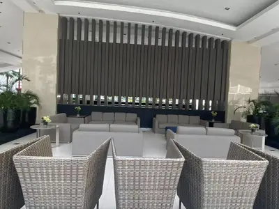 a lobby with a table and chairs and a wall at Modern Studio Condo - Shore near MOA- 403B in Manila