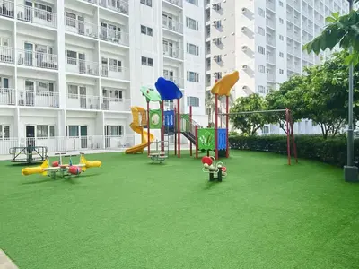 a playground in front of a large apartment building at Modern Studio Condo - Shore near MOA- 403B in Manila