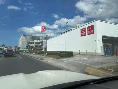 a car driving down a street next to a building at Modern Studio Condo - Shore near MOA- 403B in Manila