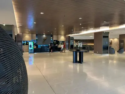 a lobby with a table in the middle of a building at Modern Studio Condo - Shore near MOA- 403B in Manila